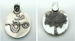 “Ohm” pendant by Kris Kramer. Fine silver. Syringe drawing (left) and carving (right).